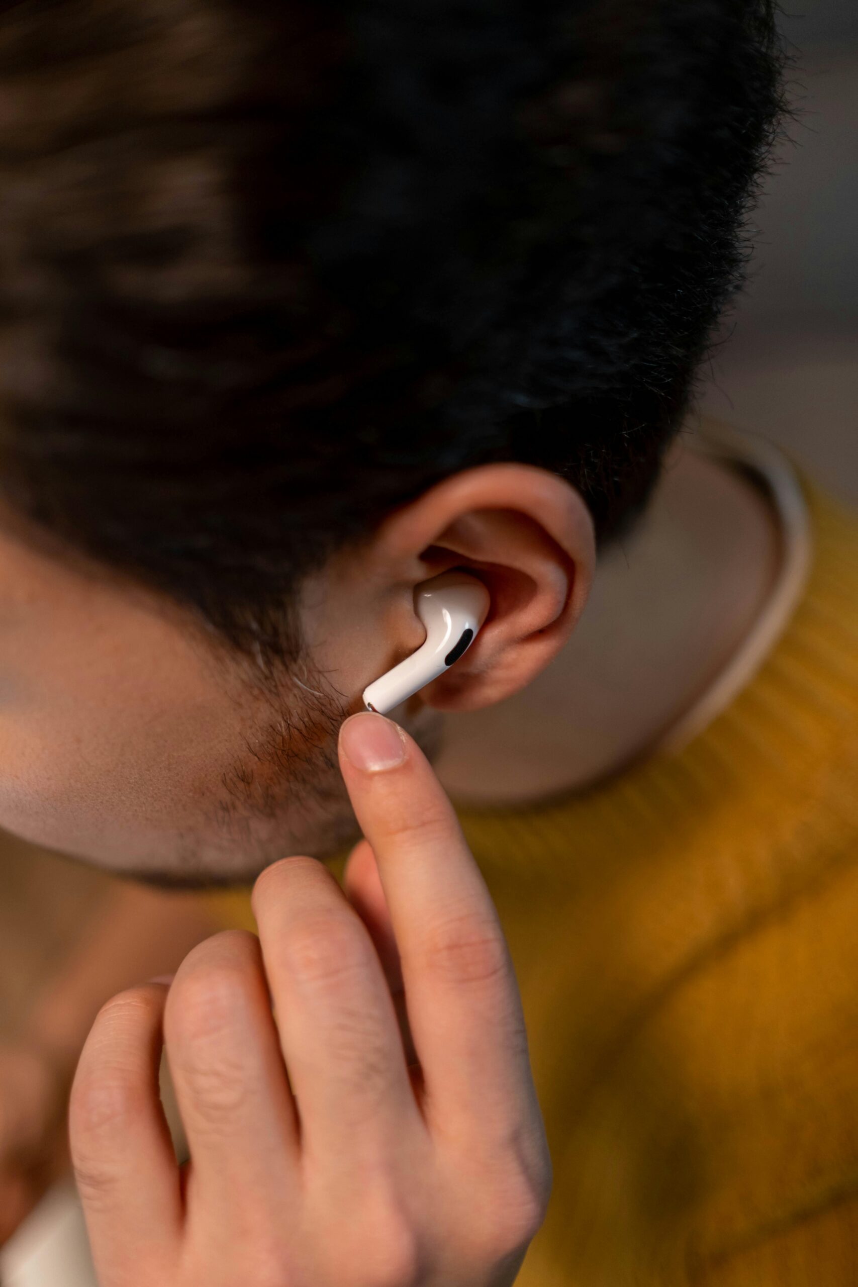Man using Apple AirPods Pro 2s as OTC hearing aids in Ohio.