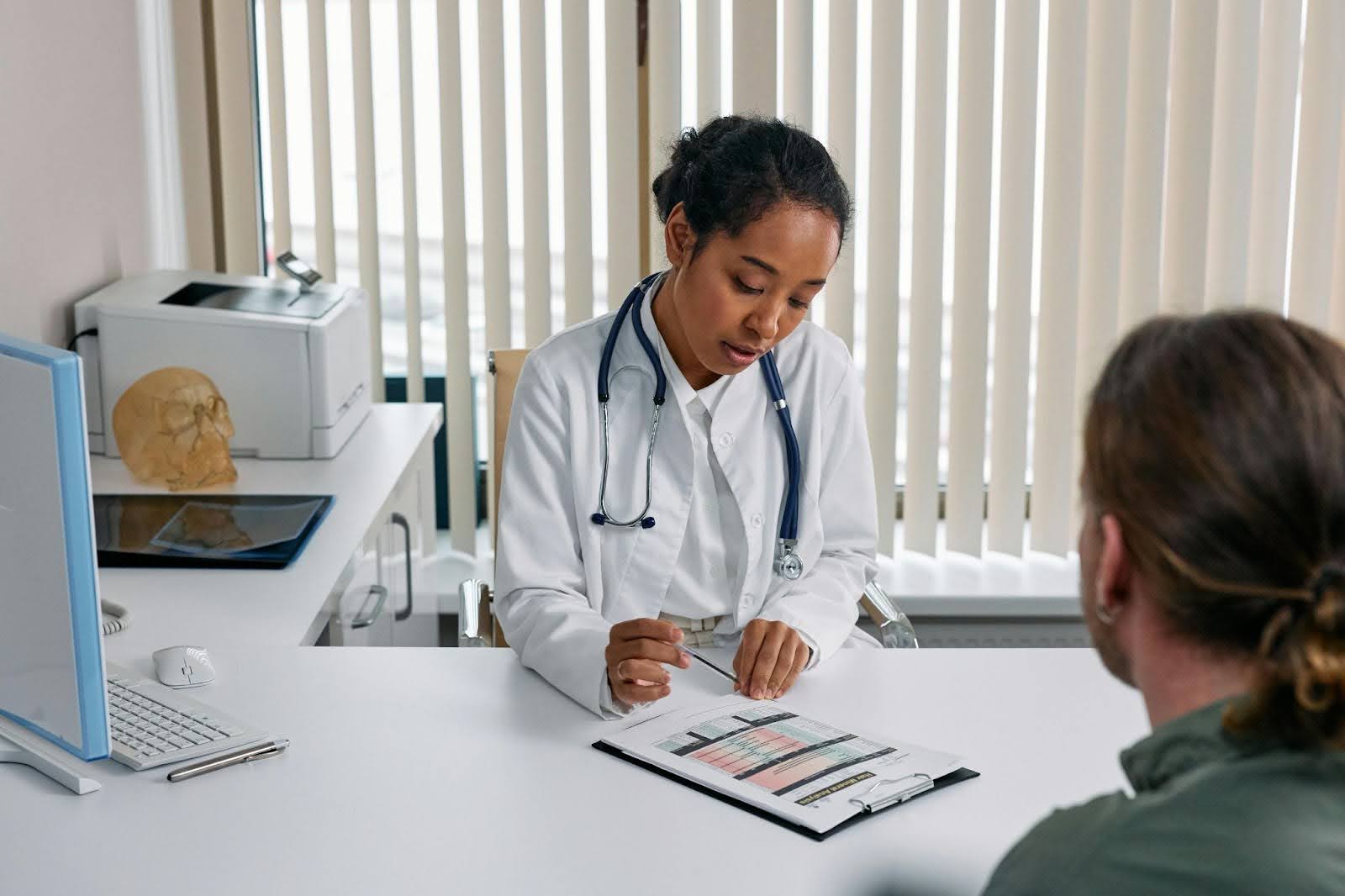 An audiologist conducting a hearing aid consultation and going over modern hearing aid technology.