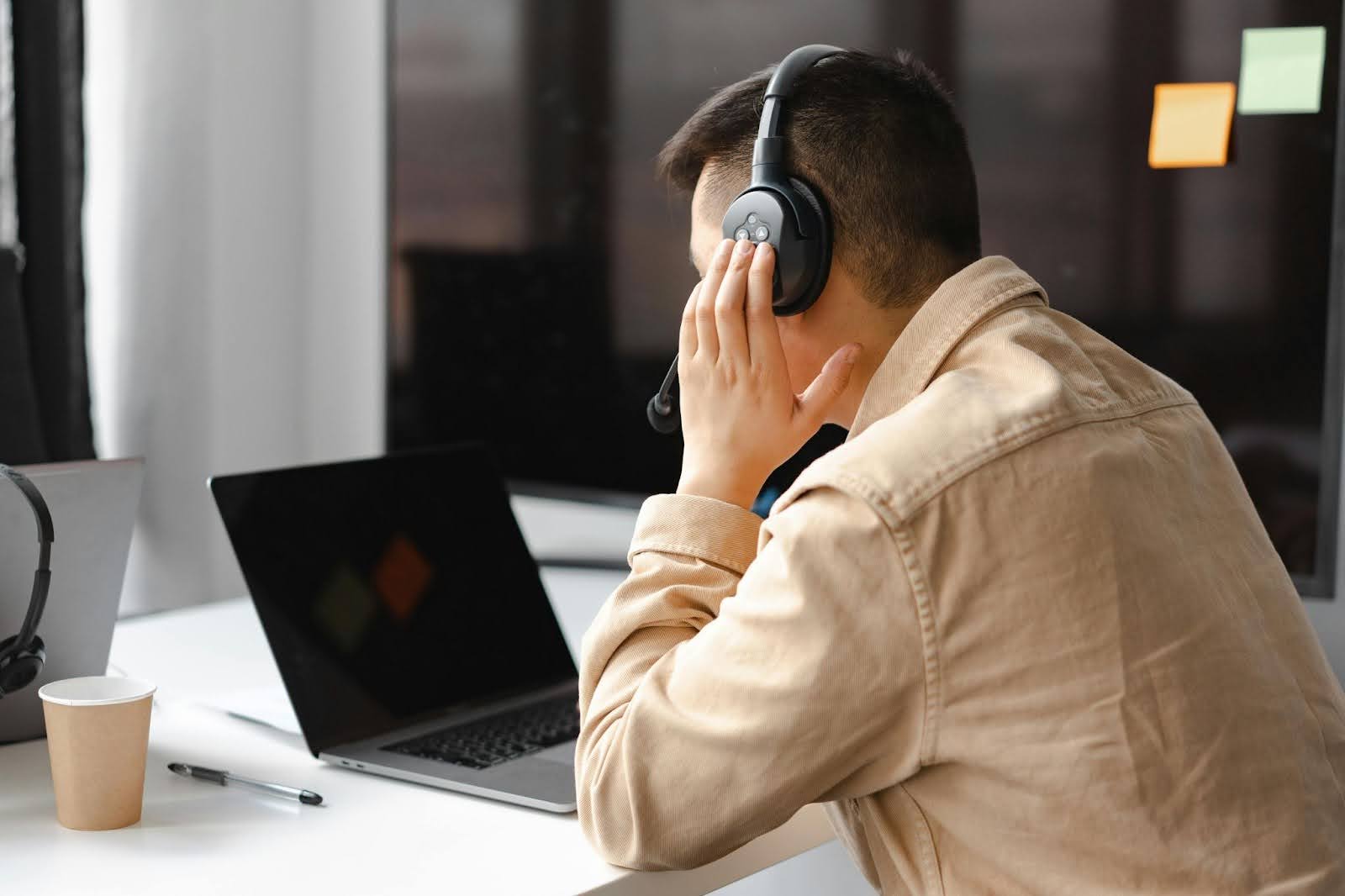 Person struggling with hearing loss at work in Ohio